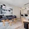 Living room with a couch a lamp a coffee table and a plant