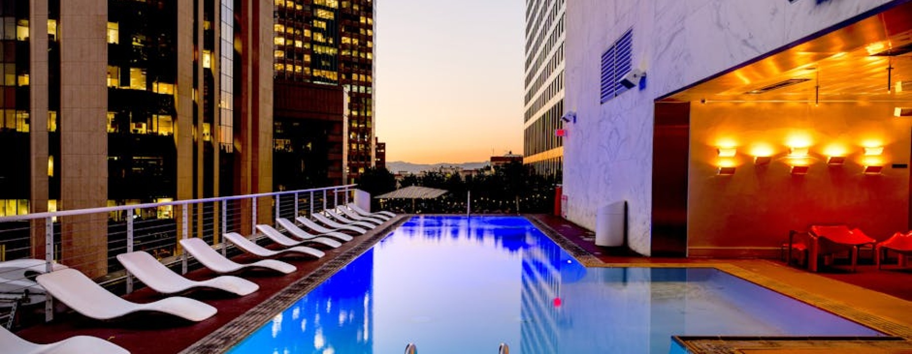 luxury rooftop pool overlooking Chicago skyline at sunset - Apartments with resort amenities
